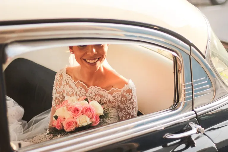 picture of a bride in a black car